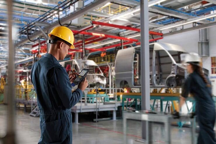 A worker using voice recognition technology in automotive manufacturing