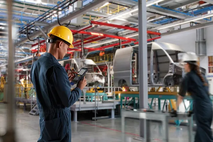 A worker using voice recognition technology in automotive manufacturing